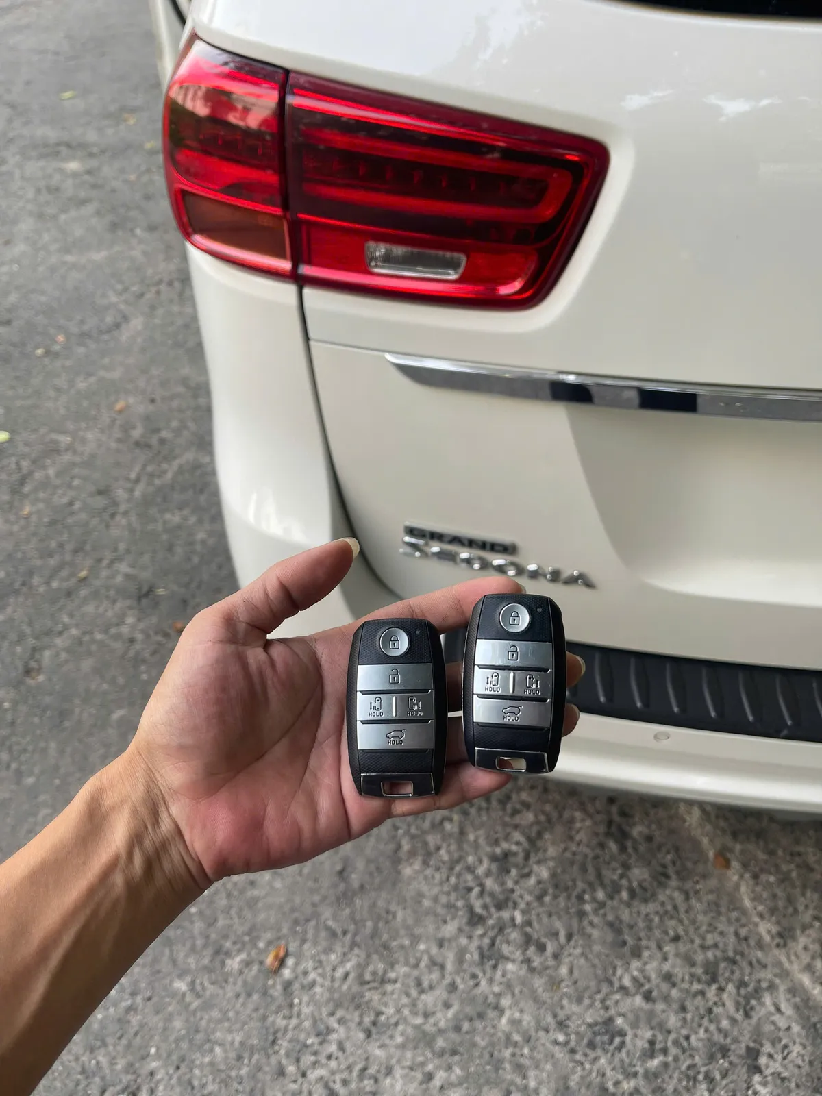 Hai chìa smartkey Kia cầm trước đuôi xe Kia Sedona màu trắng