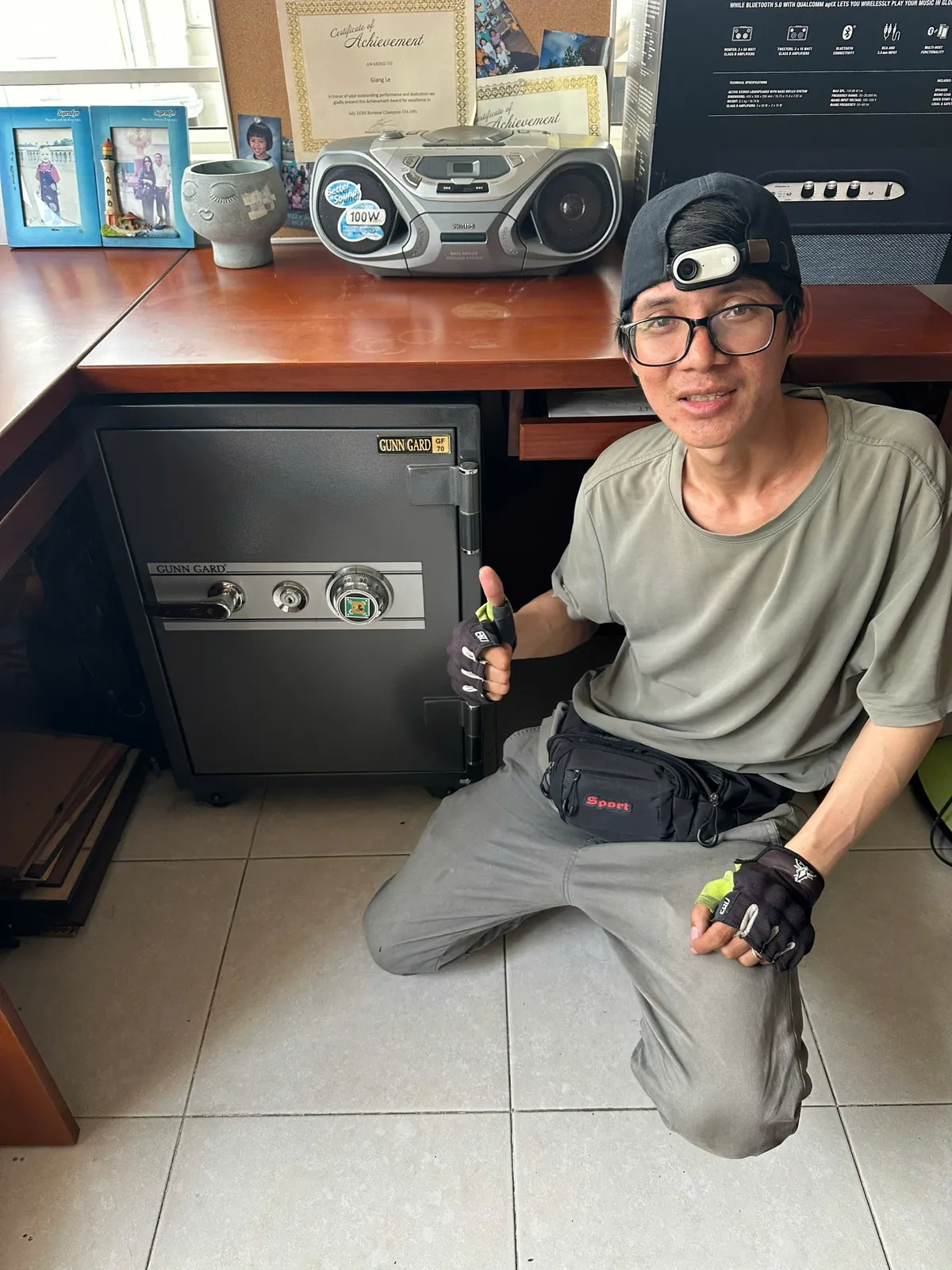 Thợ khóa Tân Phú bên két sắt đặt dưới bàn làm việc
